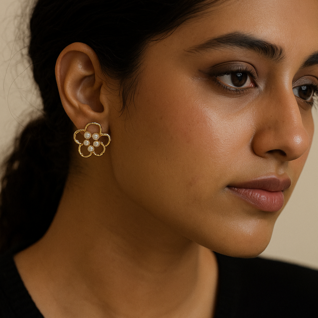 Close-up of a woman wearing a floral earring with a neutral background